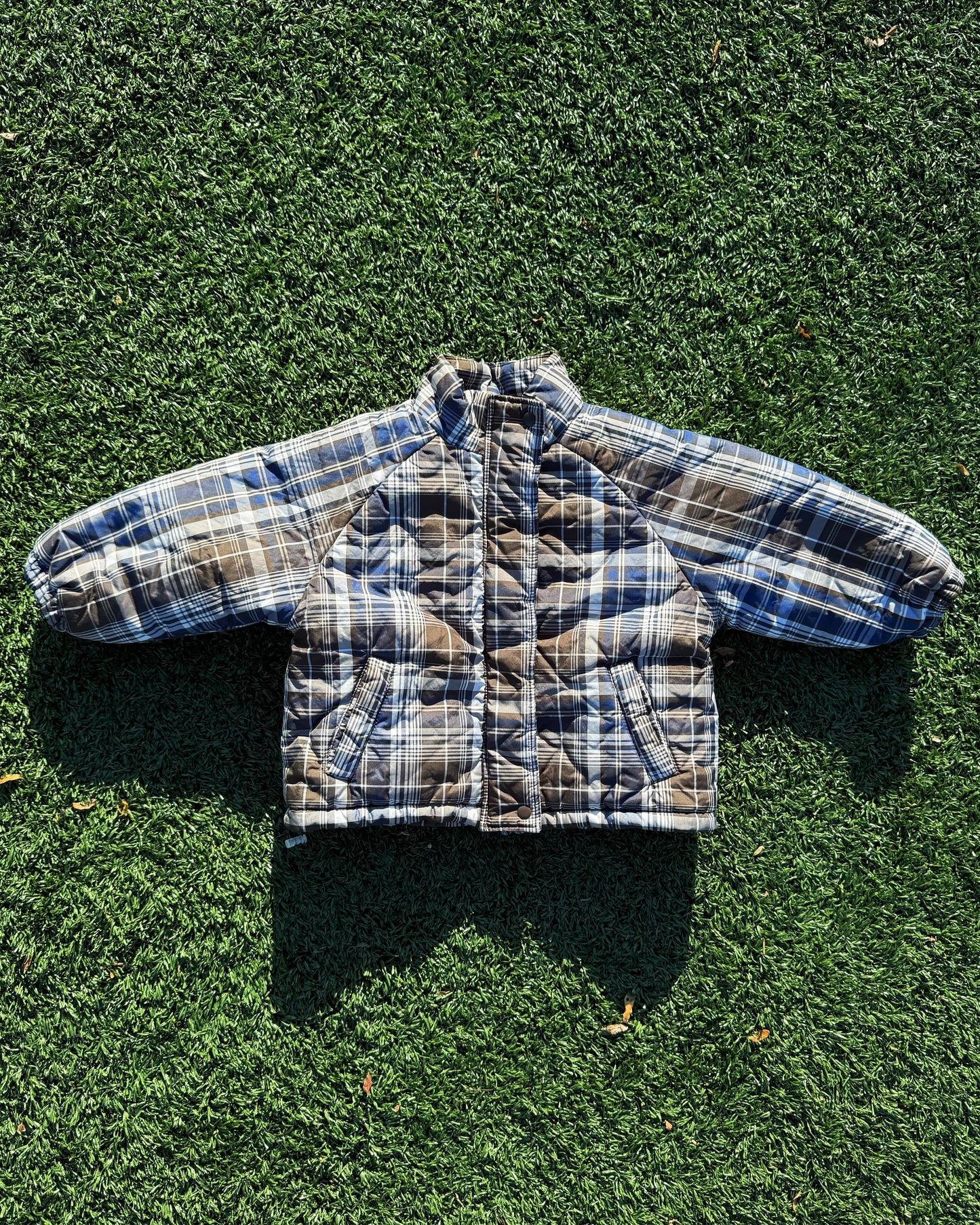 Kids padded winter plaid jacket on grass